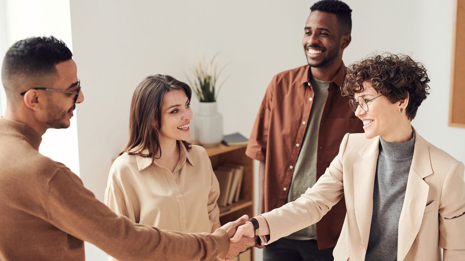 a group of people shaking hands in an office at The  Mark at 2600
