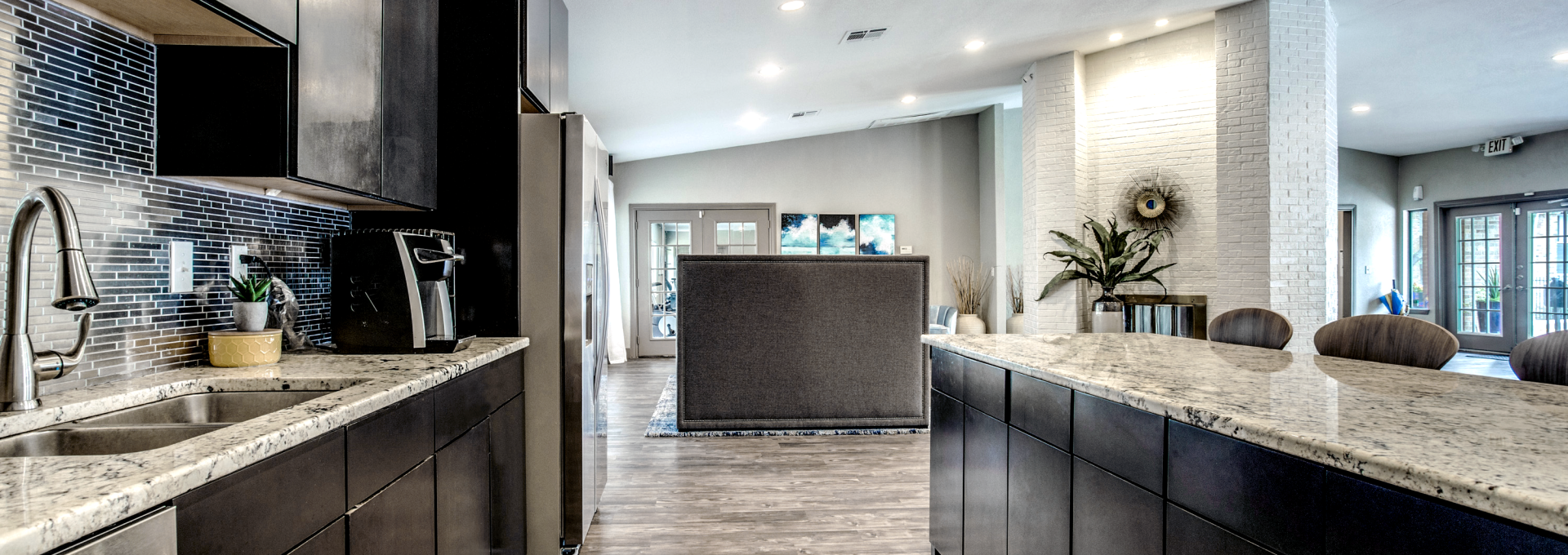 a kitchen with black cabinets and stainless steel appliances at The  Mark at 2600