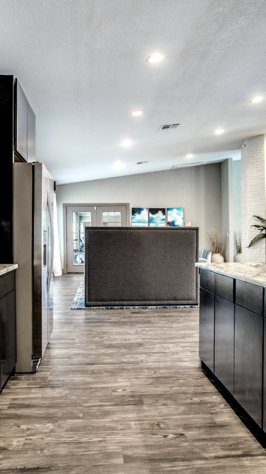 a kitchen with black cabinets and stainless steel appliances at The  Mark at 2600