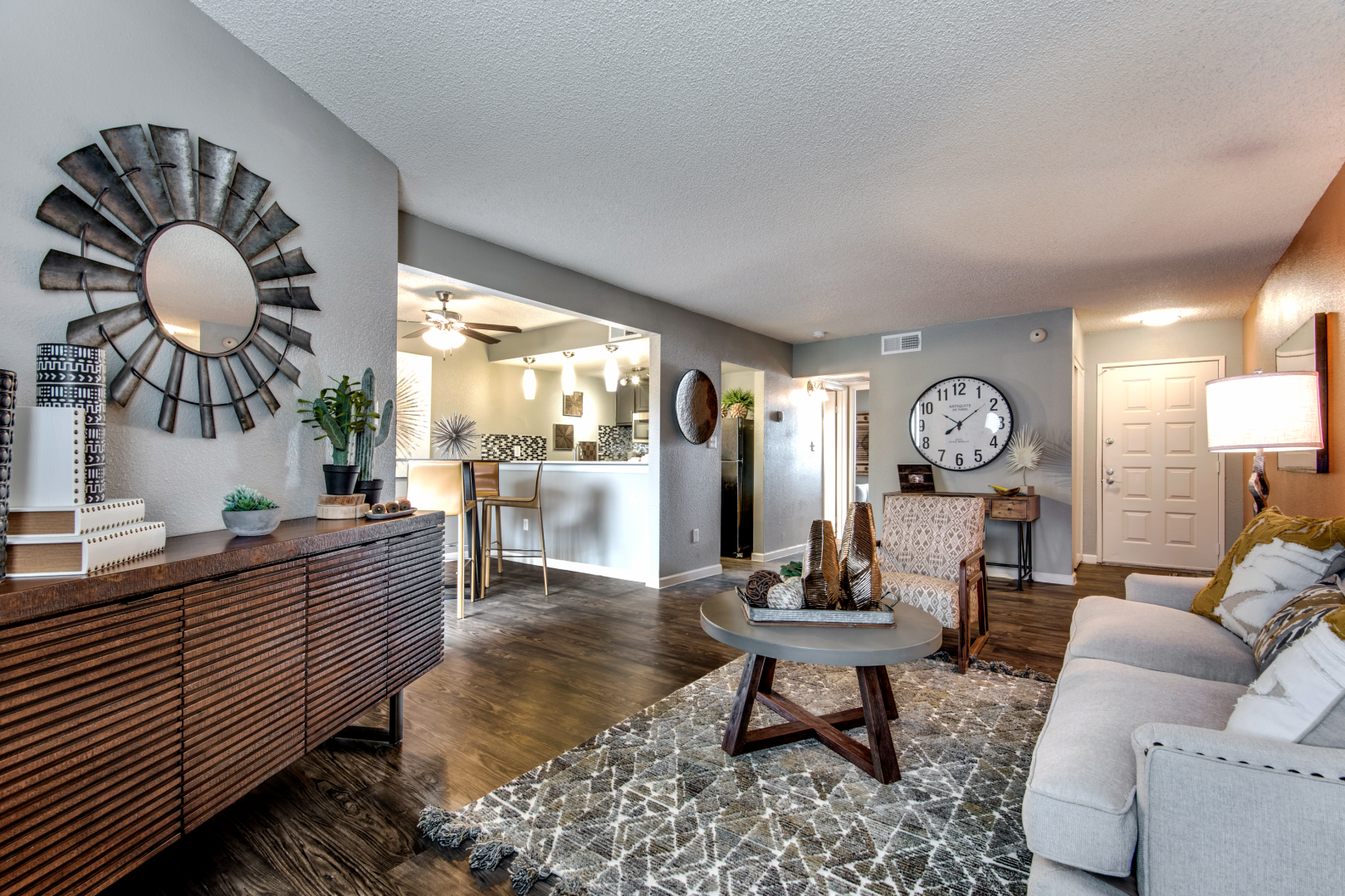 a living room with a large mirror and wood floors at The  Mark at 2600