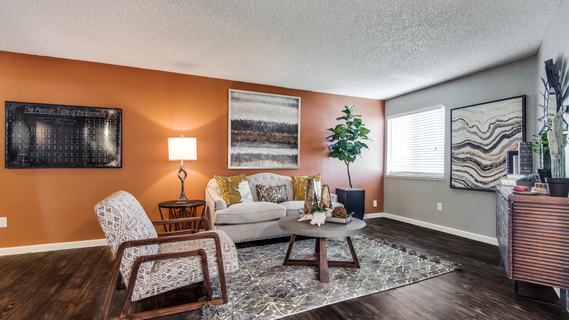 a living room with orange walls and hardwood floors at The  Mark at 2600