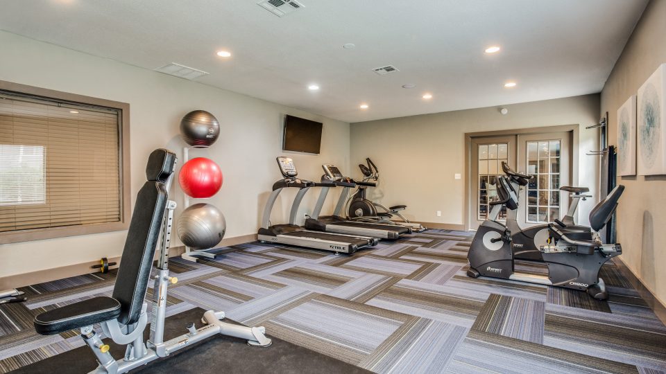 a gym room with exercise equipment and treads at The  Mark at 2600