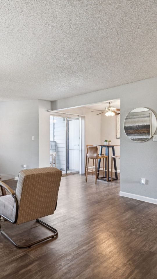 the living room has hardwood floors and a large window at The  Mark at 2600